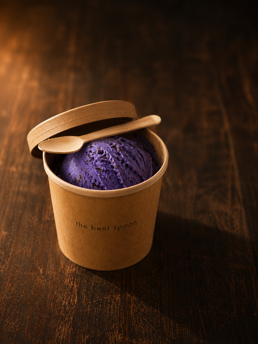 Kraft pint cup of ube ice cream with a wooden spoon, the bent spoon branding